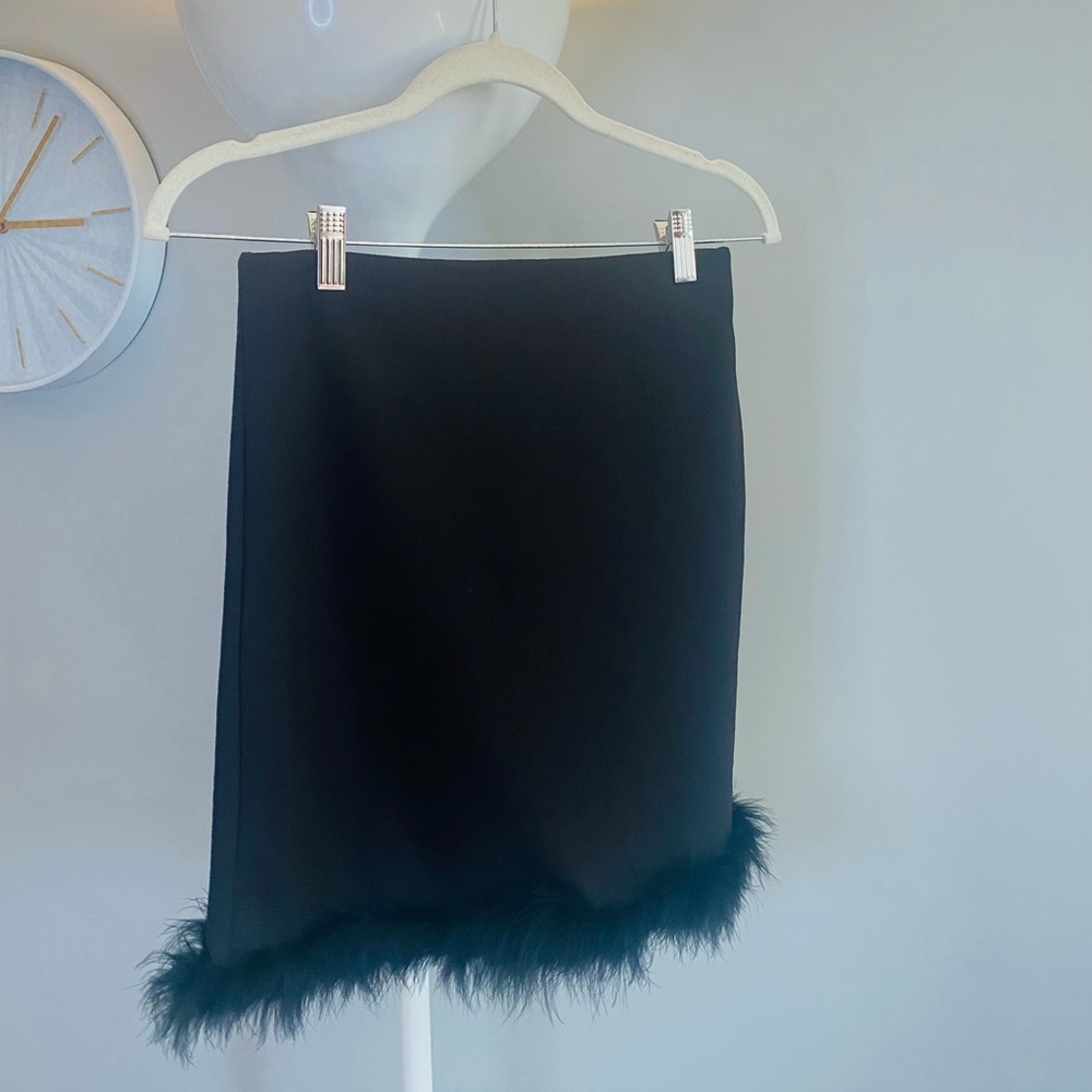 Black mini skirt with fur trim.